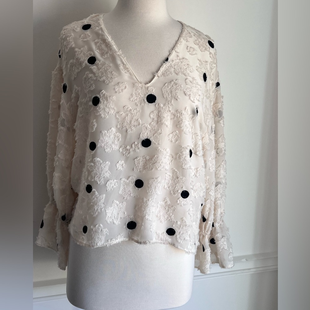 Zara cream top with ruffle sleeve and black embellishments. Size XS/S